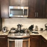 Furnished apartment kitchen stocked with Habitas housewares package
